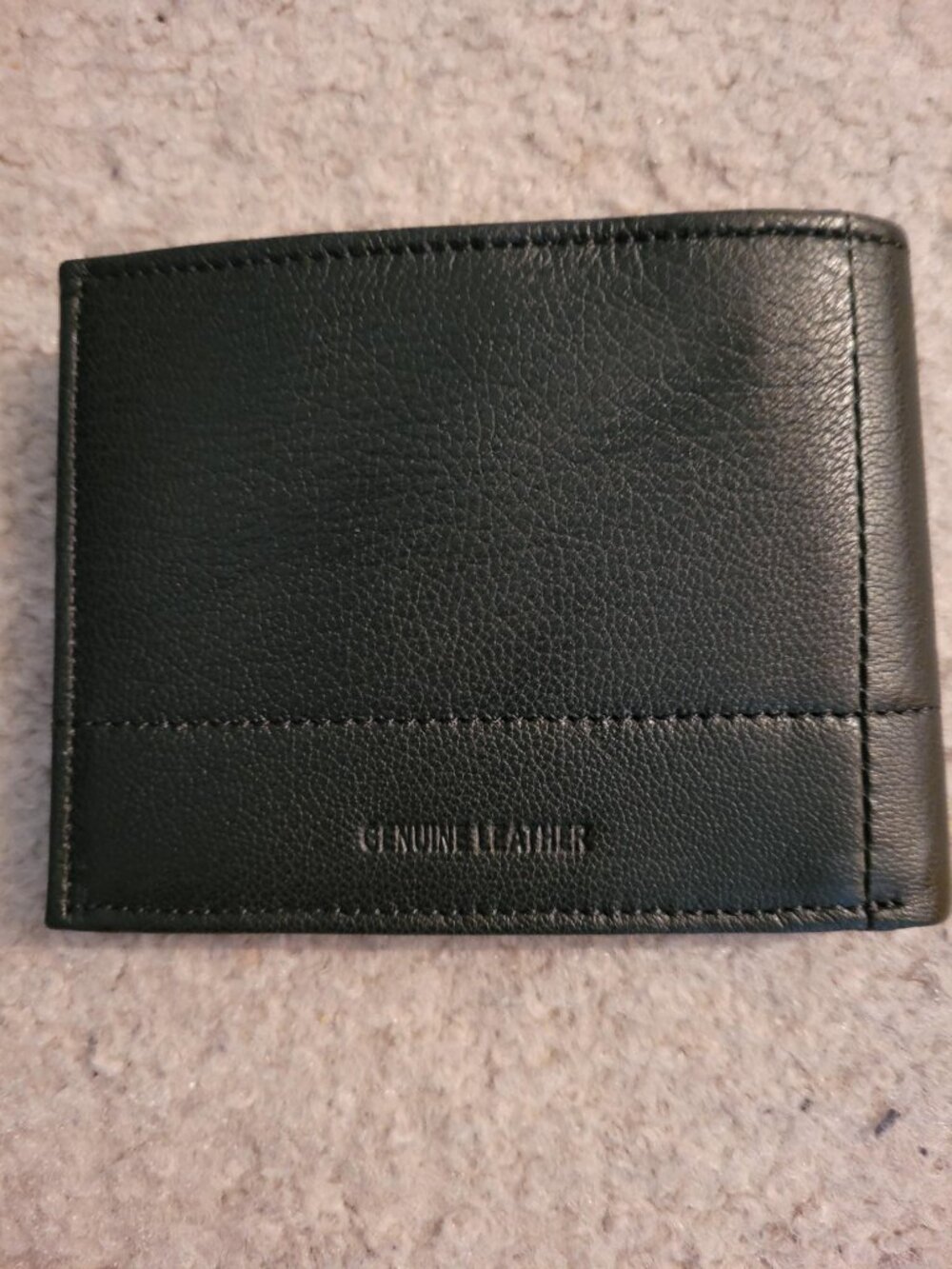 New, never used Perry Ellis black genuine leather wallet.